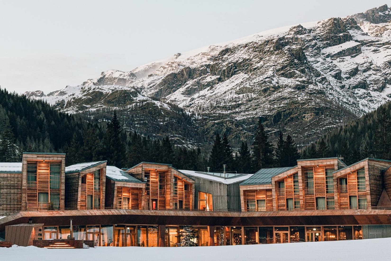 Italian alpine design hotel with swimming pool, spa and flexible meeting spaces surrounded by forests and peaks