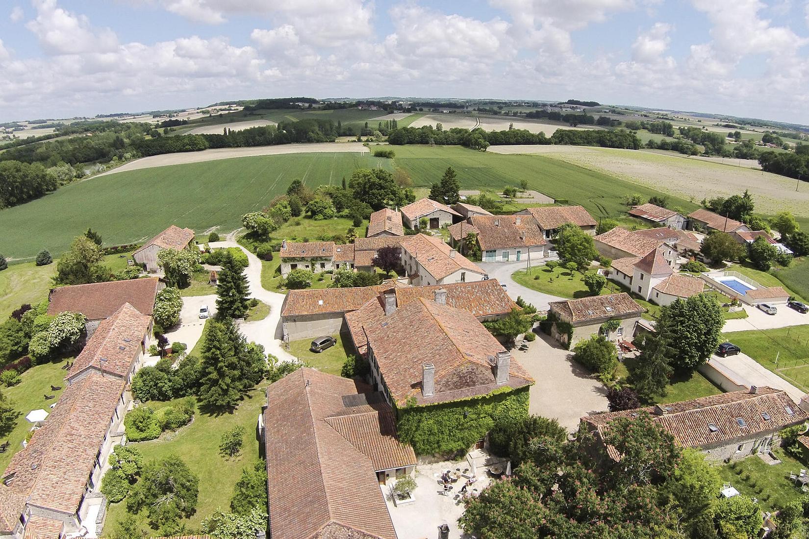 Village-style French manor estate with pools, tennis courts and large event barn